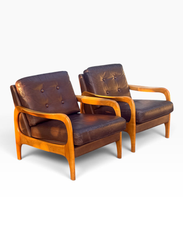 Pair of Danish modern brown leather lounge chairs with sculpted maple frames