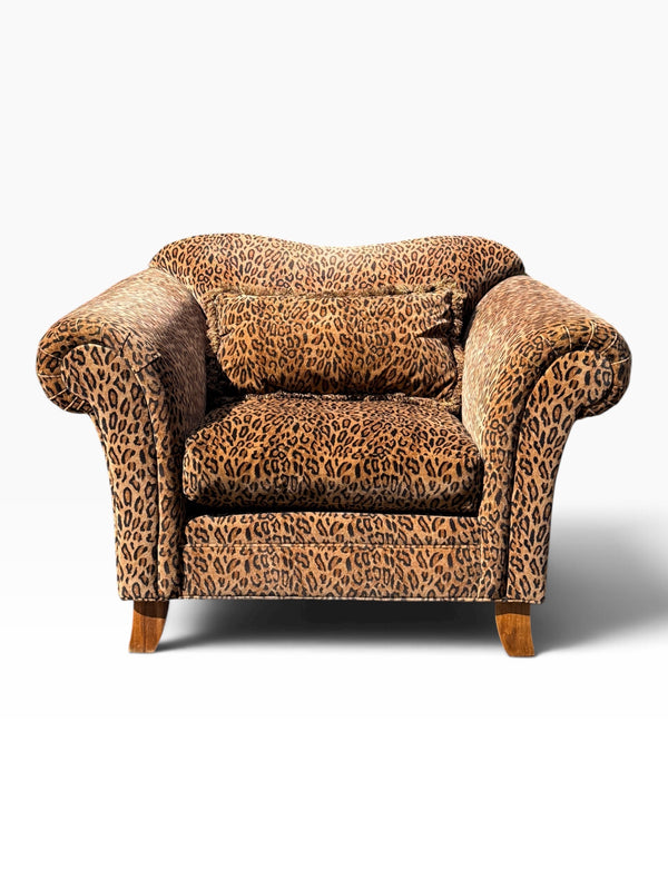 Oversized leopard print club lounge chair front view with bolster pillow