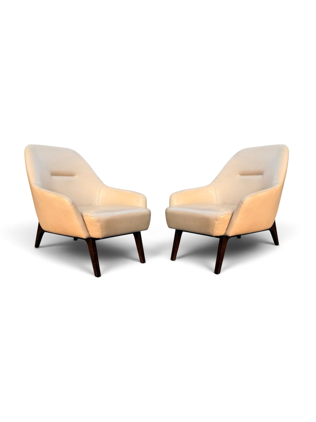 Pair of Adam Court cream leather lounge chairs on dark walnut frames