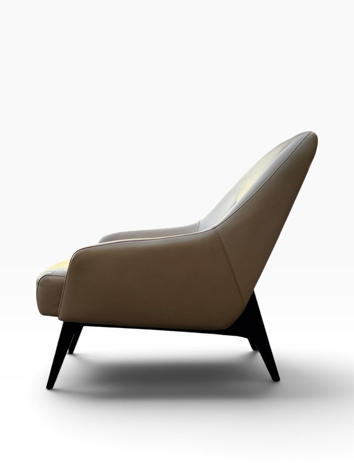 Adam Court lounge chair side profile with angled walnut legs