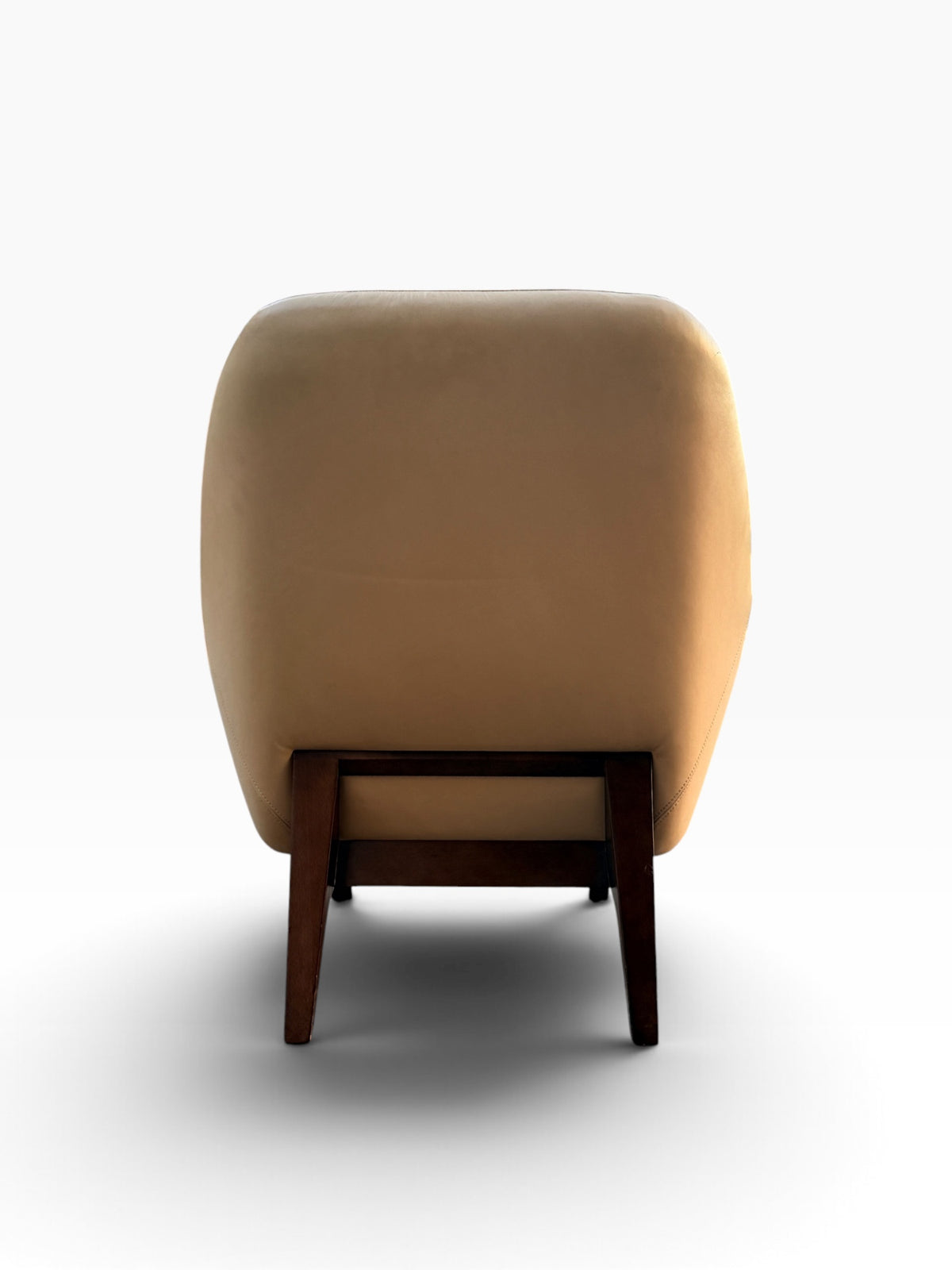 Back view of cream leather lounge chair showing walnut frame