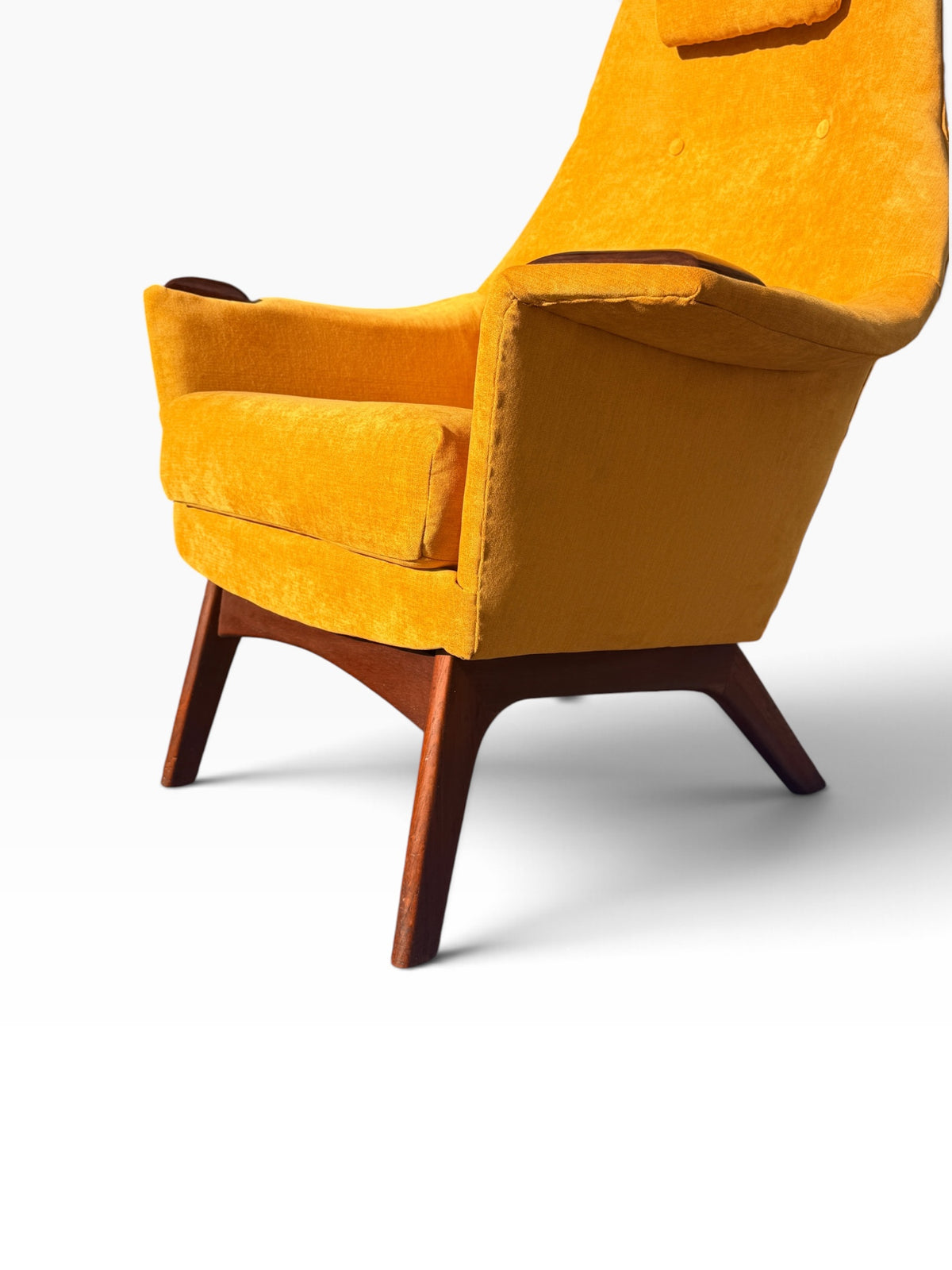 Low angle view of Pearsall lounge chair seat, arms and walnut base