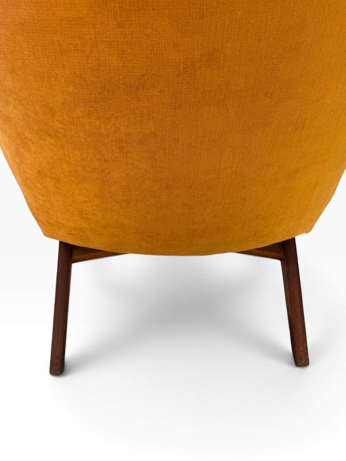 Rear detail of upholstered back and walnut legs