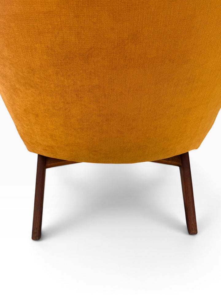 Rear detail of upholstered back and walnut legs