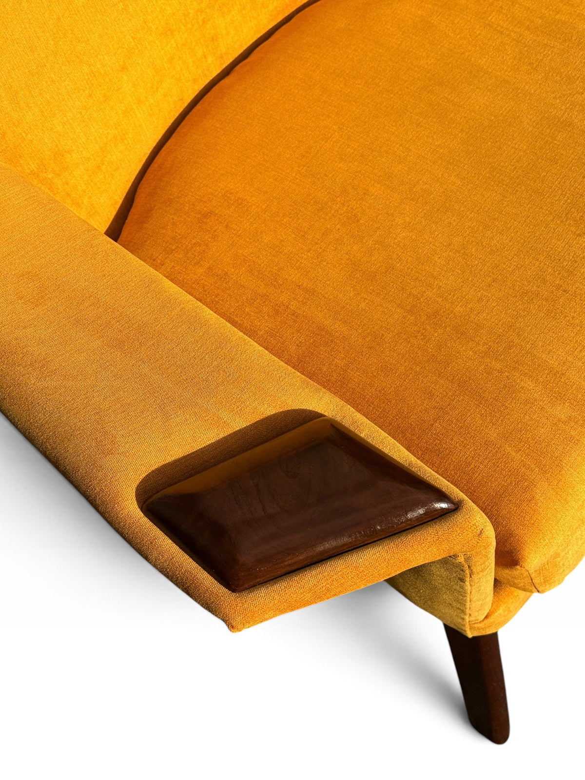 Carved walnut arm cap detail on Pearsall lounge chair