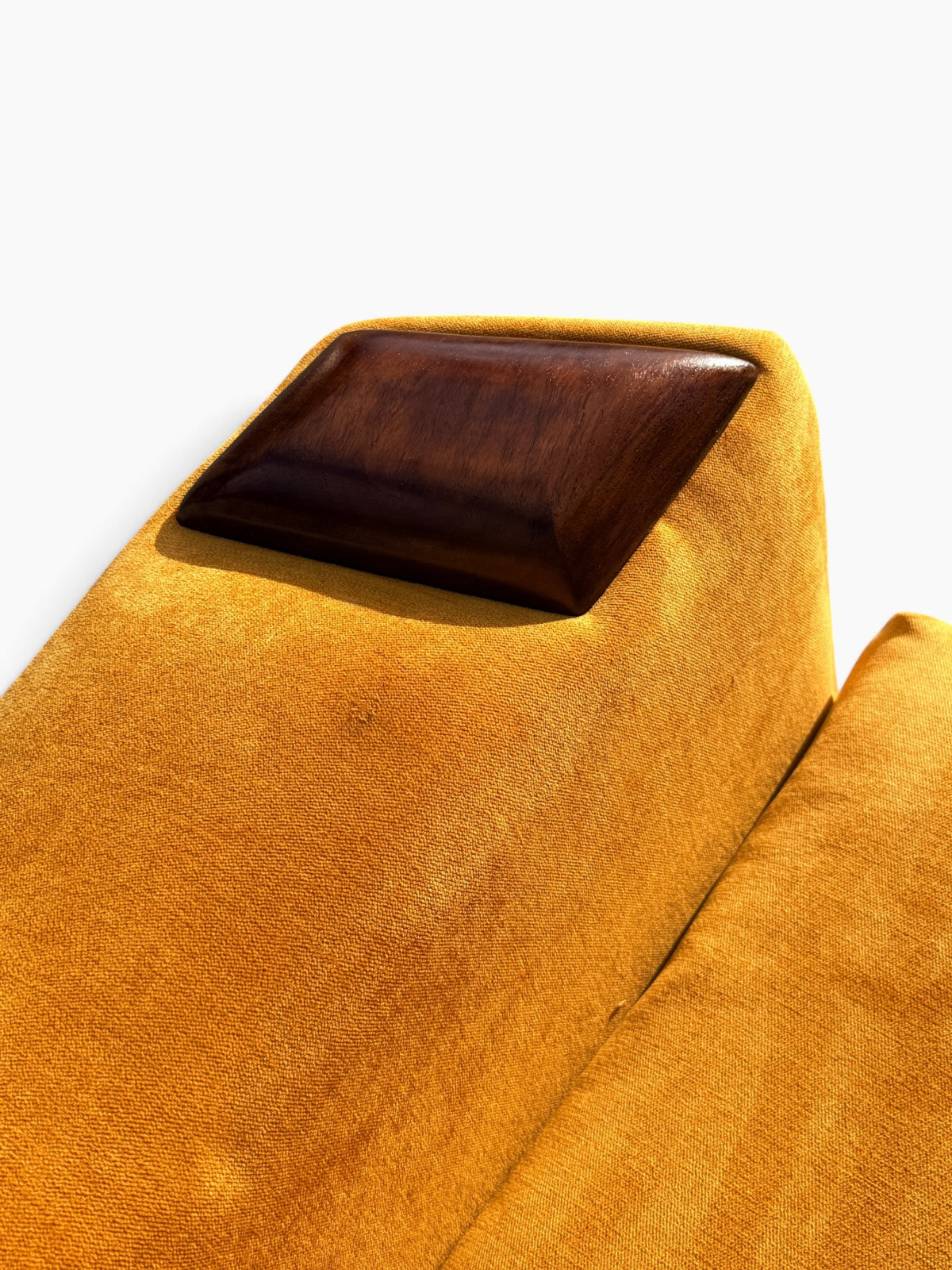 Close-up of sculpted walnut arm cap