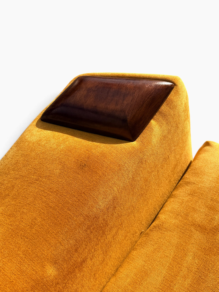 Close-up of sculpted walnut arm cap
