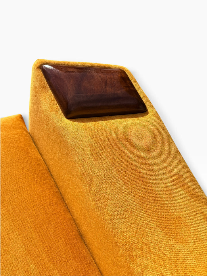 Walnut arm cap and upholstered arm detail
