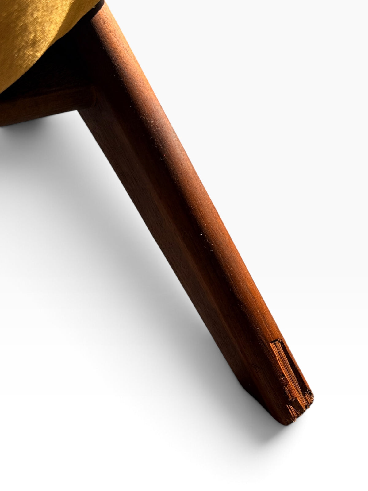 Back leg detail showing minor chip to walnut