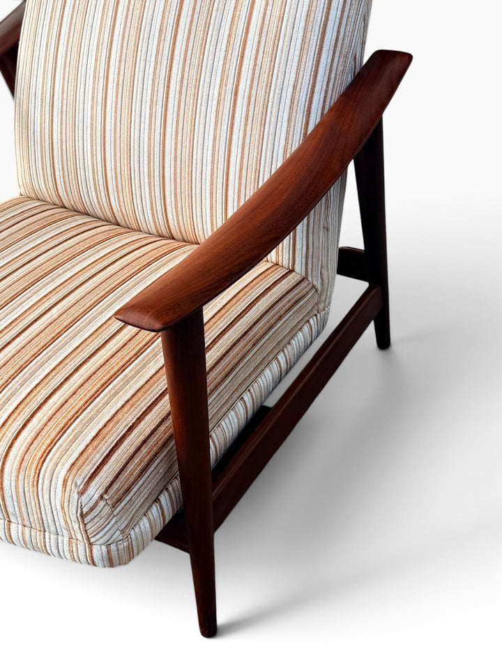 Curved walnut armrest and striped upholstery detail