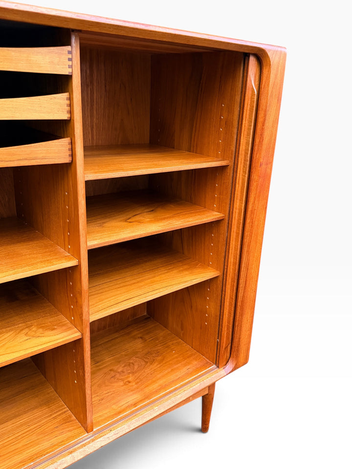 Adjustable teak shelving behind the tambour door
