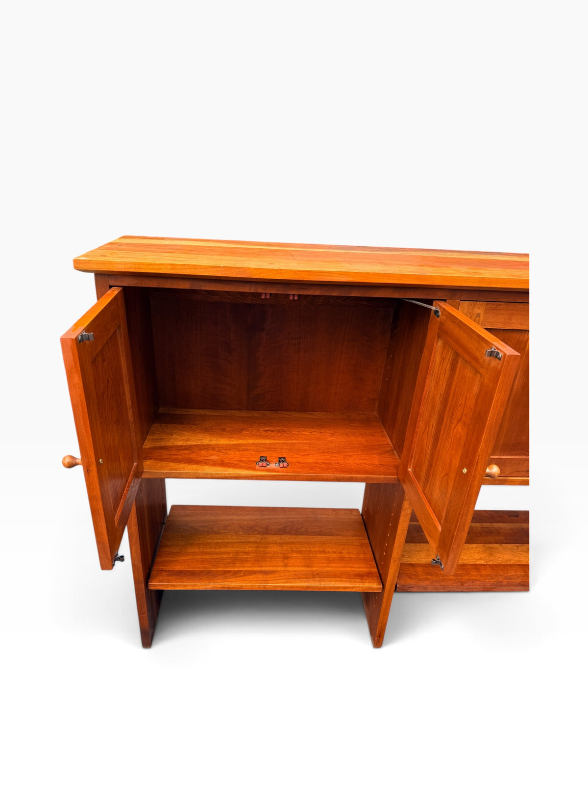 Interior of cherry cabinet bay with shelf and magnetic catches