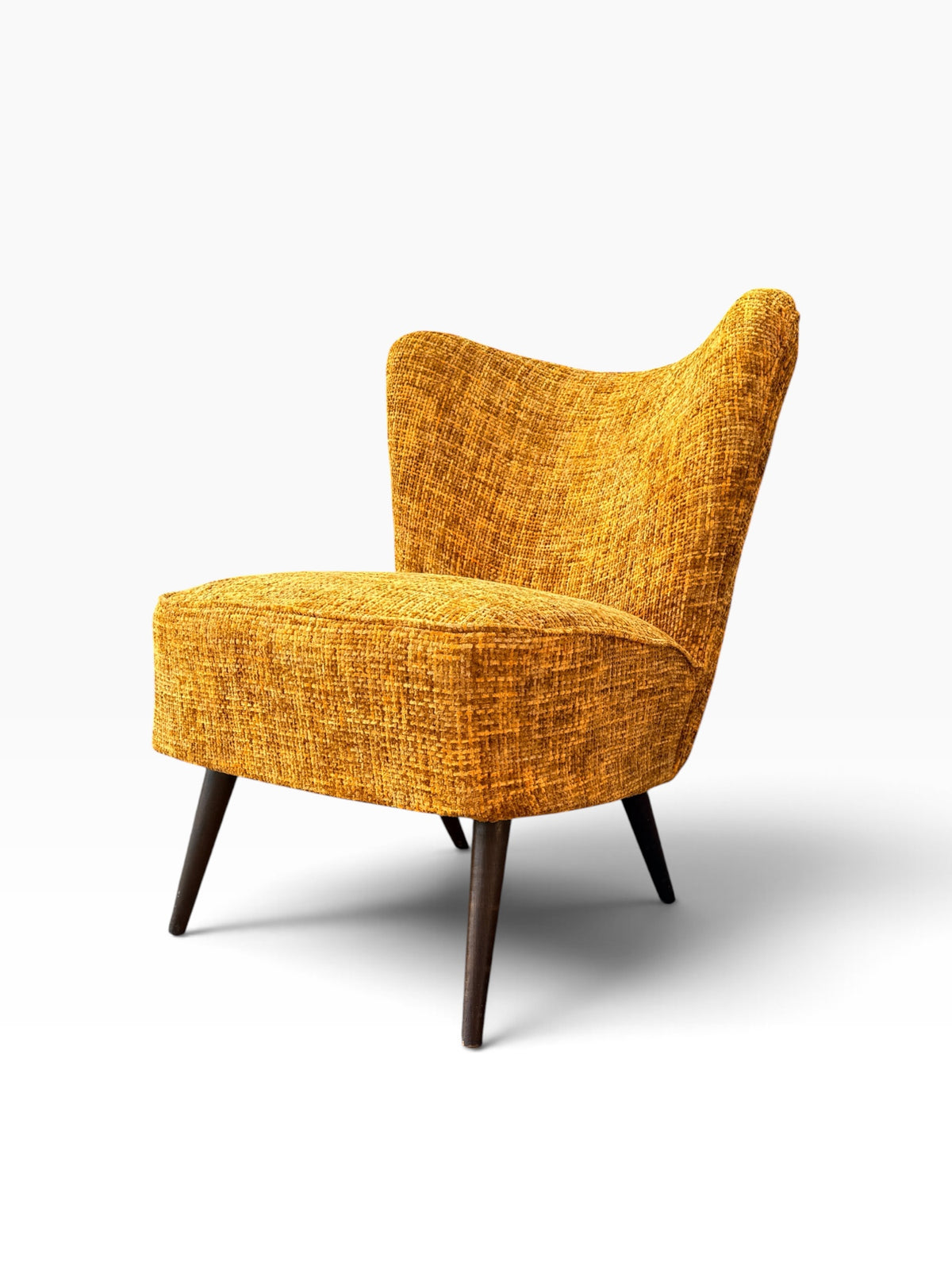 Mid-century cocktail chair with winged back, three-quarter view