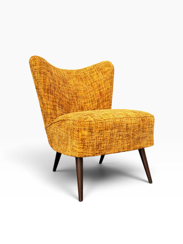 Danish cocktail chair on tapered splayed legs, three-quarter view