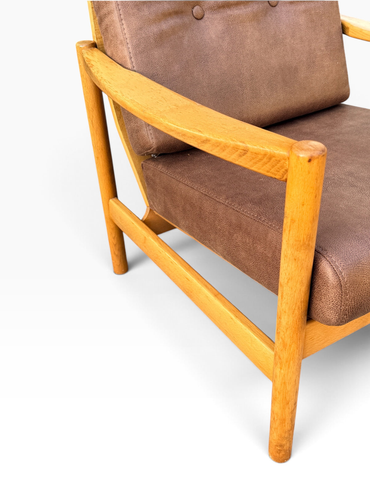 Close-up of sculpted armrest and wood frame