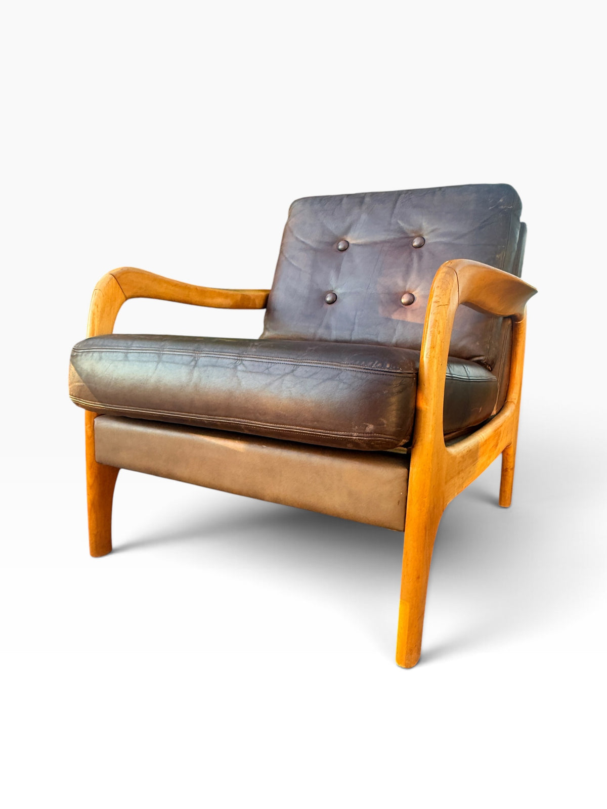 Single brown leather lounge chair, three-quarter view