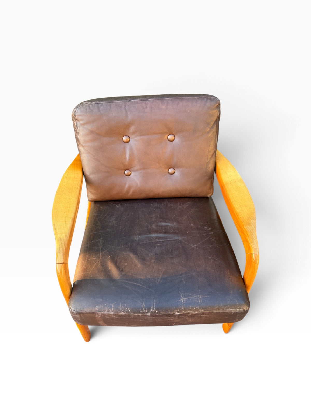Leather lounge chair from above showing tufted back cushion