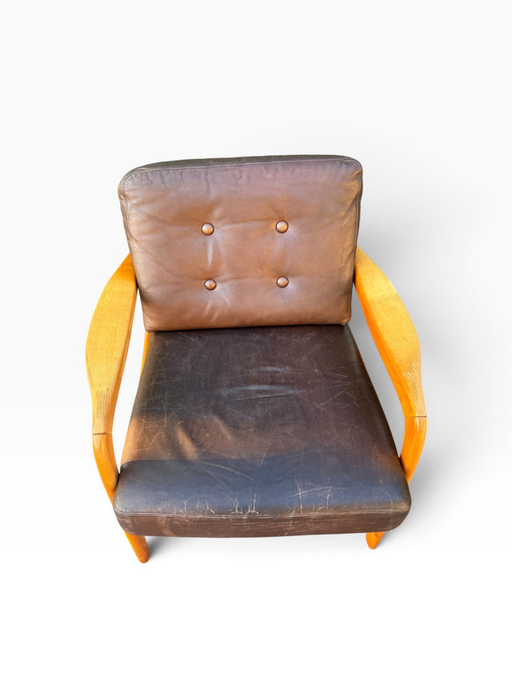Leather lounge chair from above showing tufted back cushion
