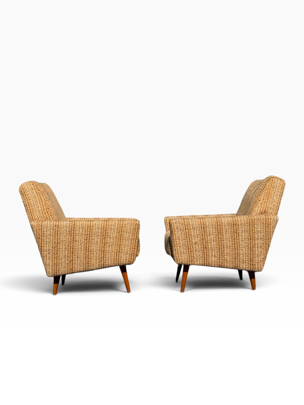 Pair of Danish modern lounge chairs, side profile showing angled back and splayed legs