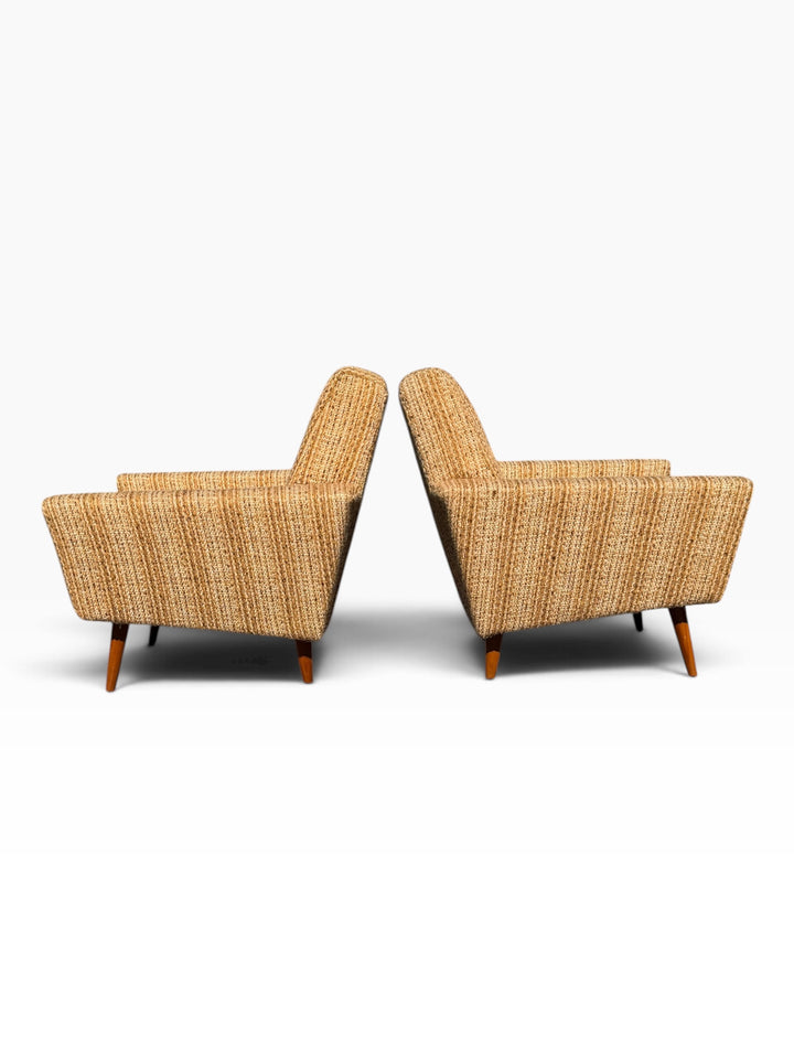 Pair of Danish modern lounge chairs, side profiles back to back