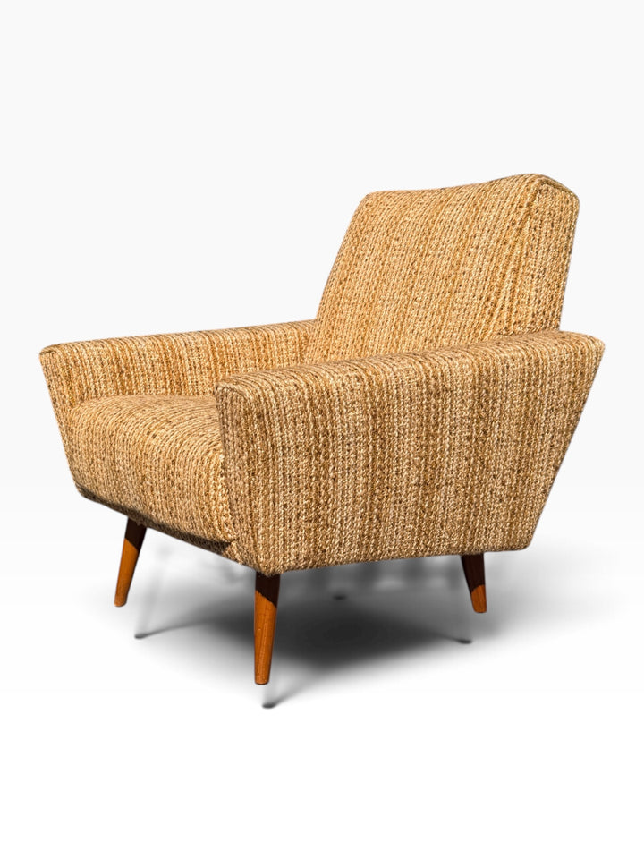 Single Danish modern lounge chair, three-quarter view of flared trapezoid arms