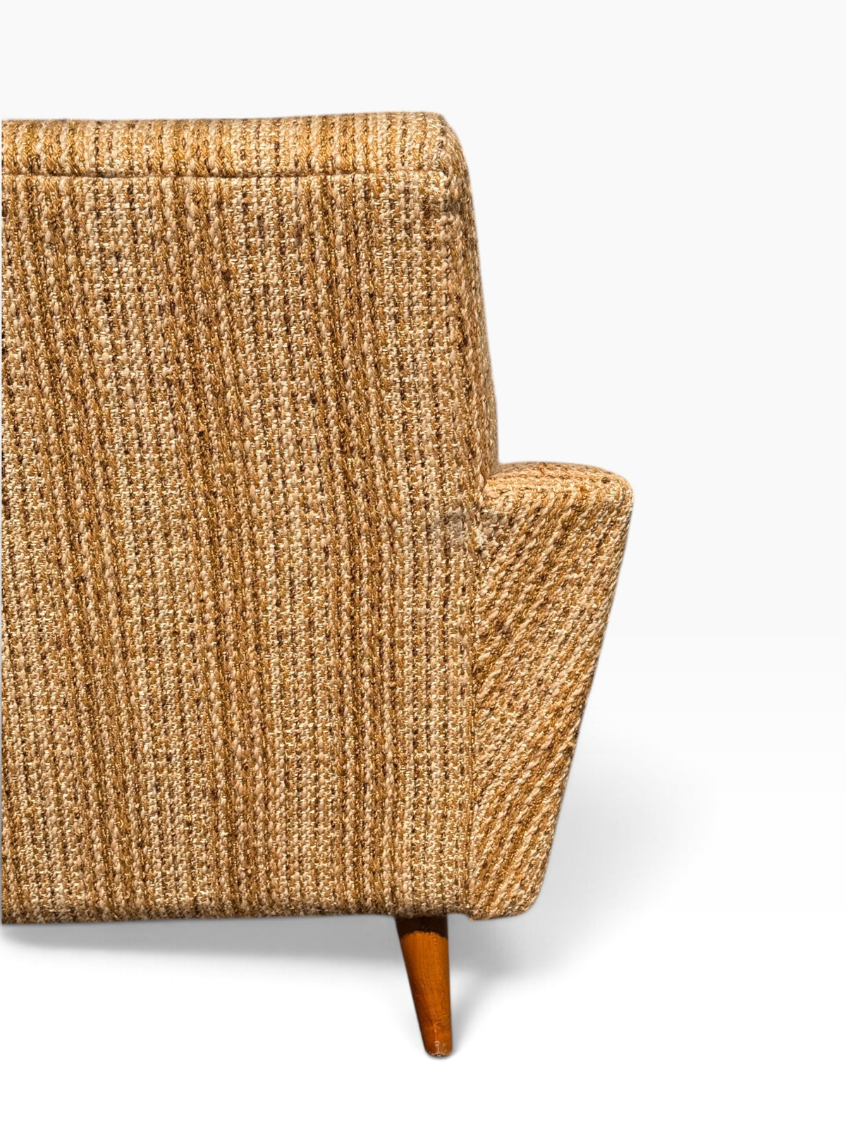 Close-up of woven tweed upholstery on chair back and arm