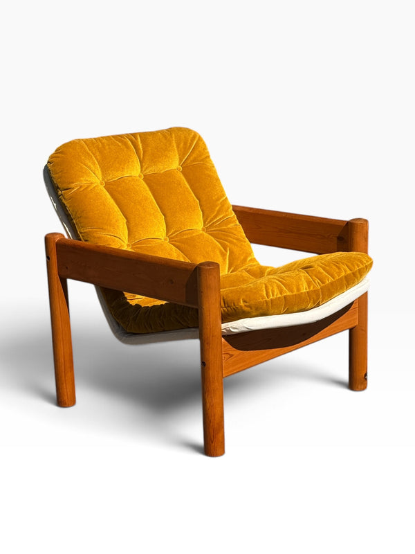Danish modern solid pine lounge armchair with mustard velvet tufted cushion, three-quarter view