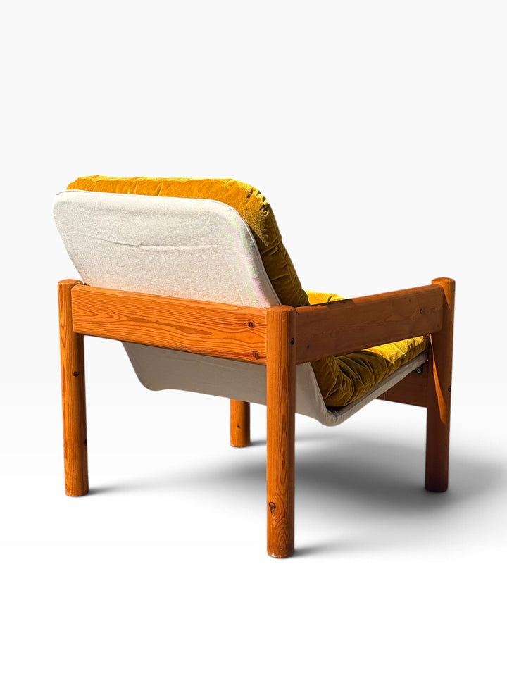 Rear three-quarter view of the Danish pine lounge armchair