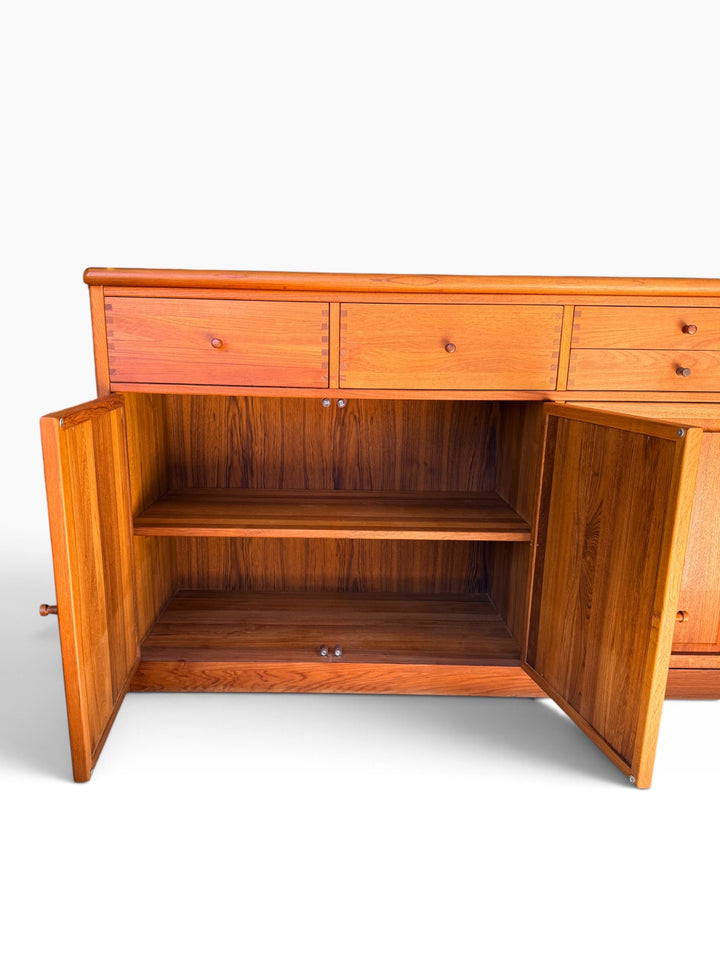 Teak sideboard with doors open showing interior shelves