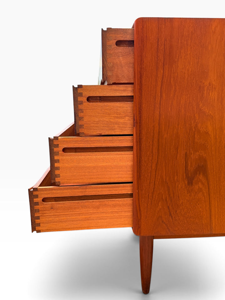 Close view of dovetailed teak drawer boxes and tapered leg