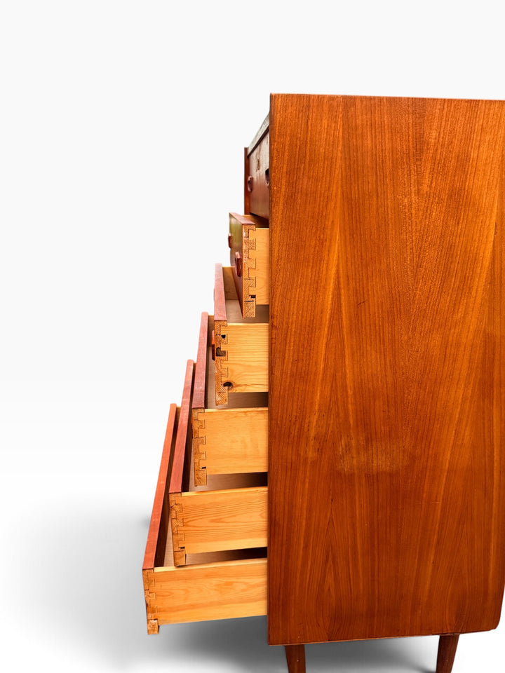 Teak dresser with drawers open, side view