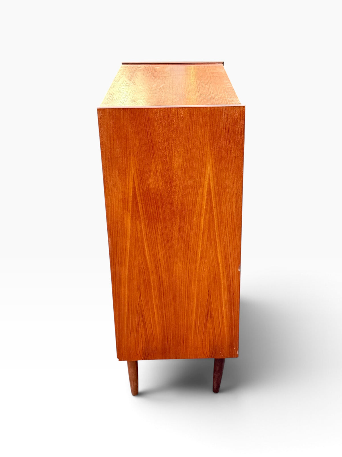 Teak tallboy side view with book-matched grain