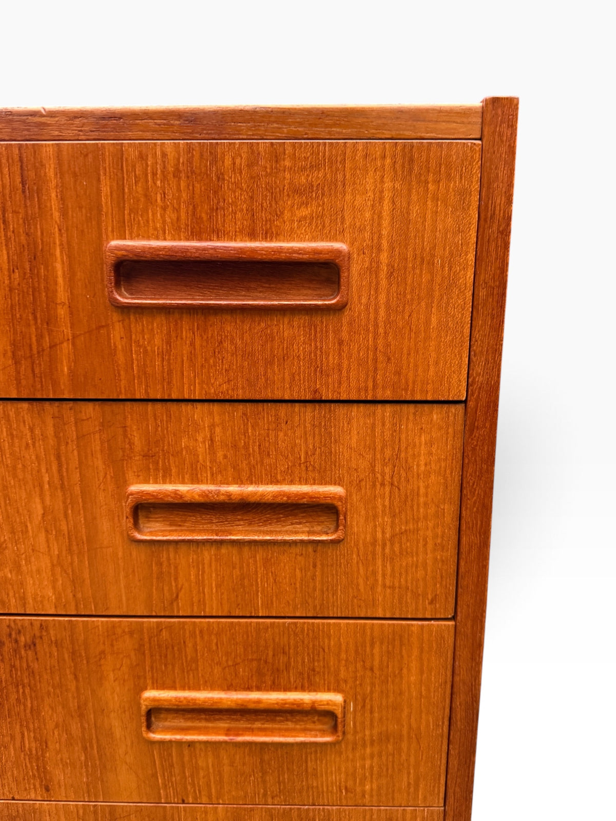 Recessed carved teak drawer pulls close-up