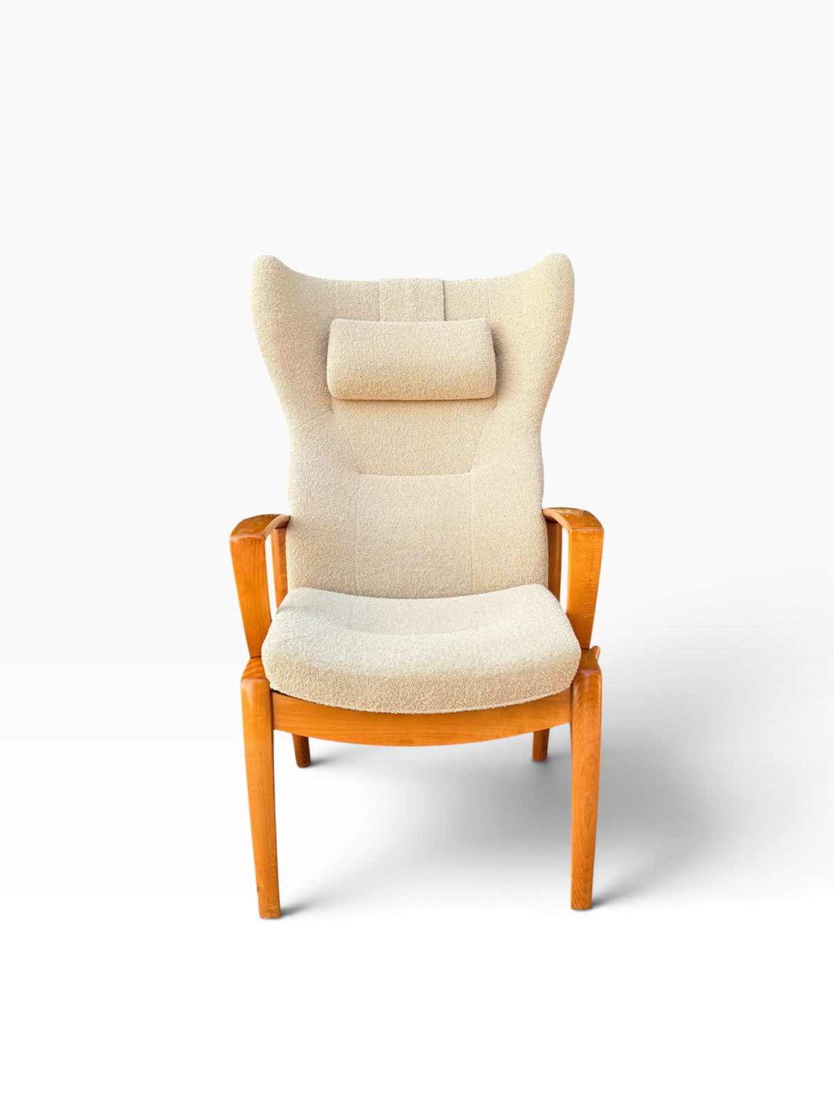 Danish modern high wingback recliner in cream boucle with headrest pillow, front view