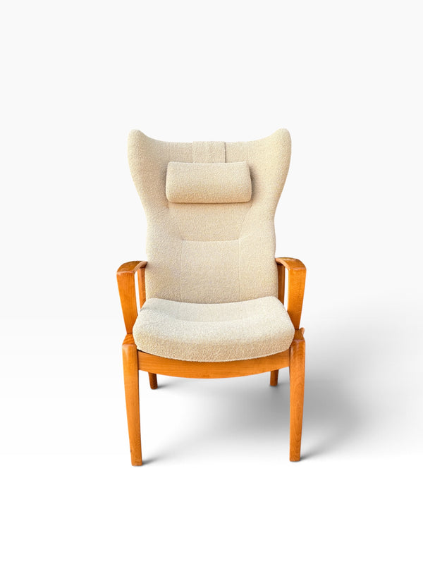 Danish modern high wingback recliner in cream boucle with headrest pillow, front view