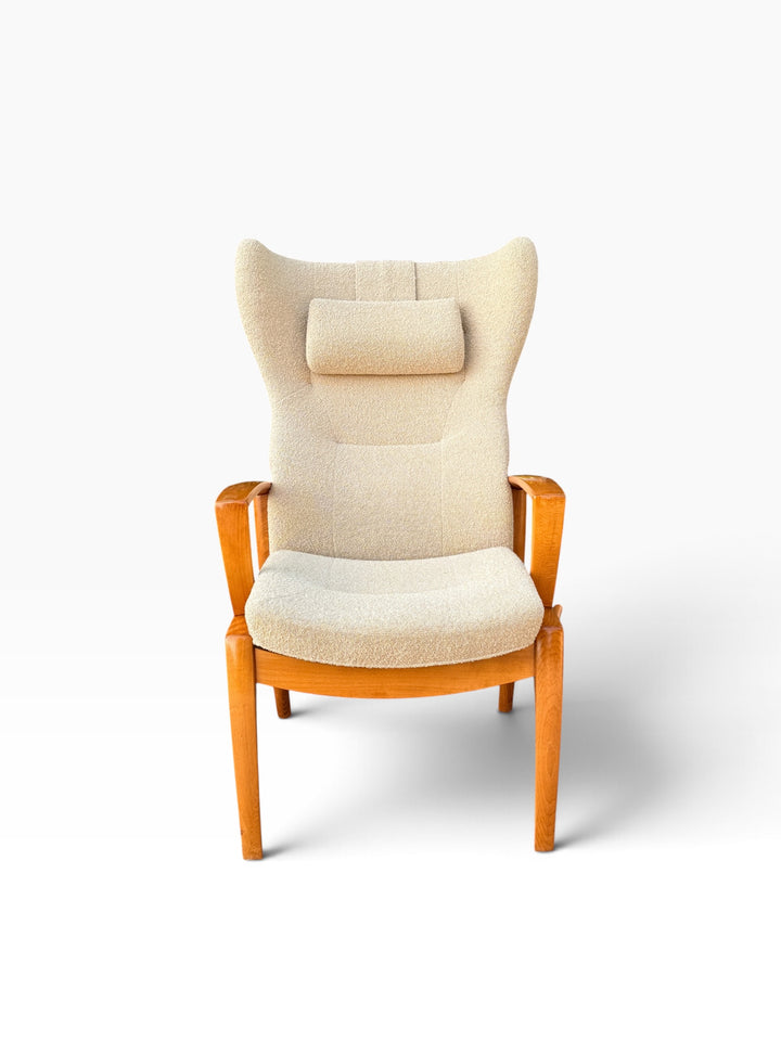Danish modern high wingback recliner in cream boucle with headrest pillow, front view