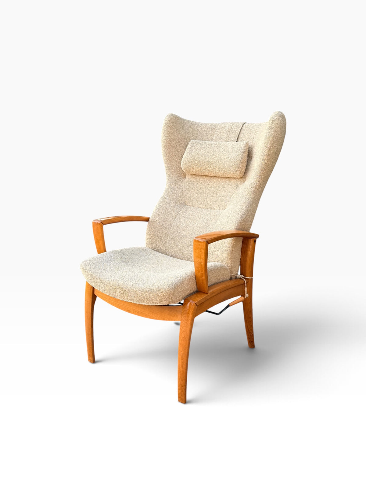 Wingback recliner with sculpted wood armrests, three-quarter view