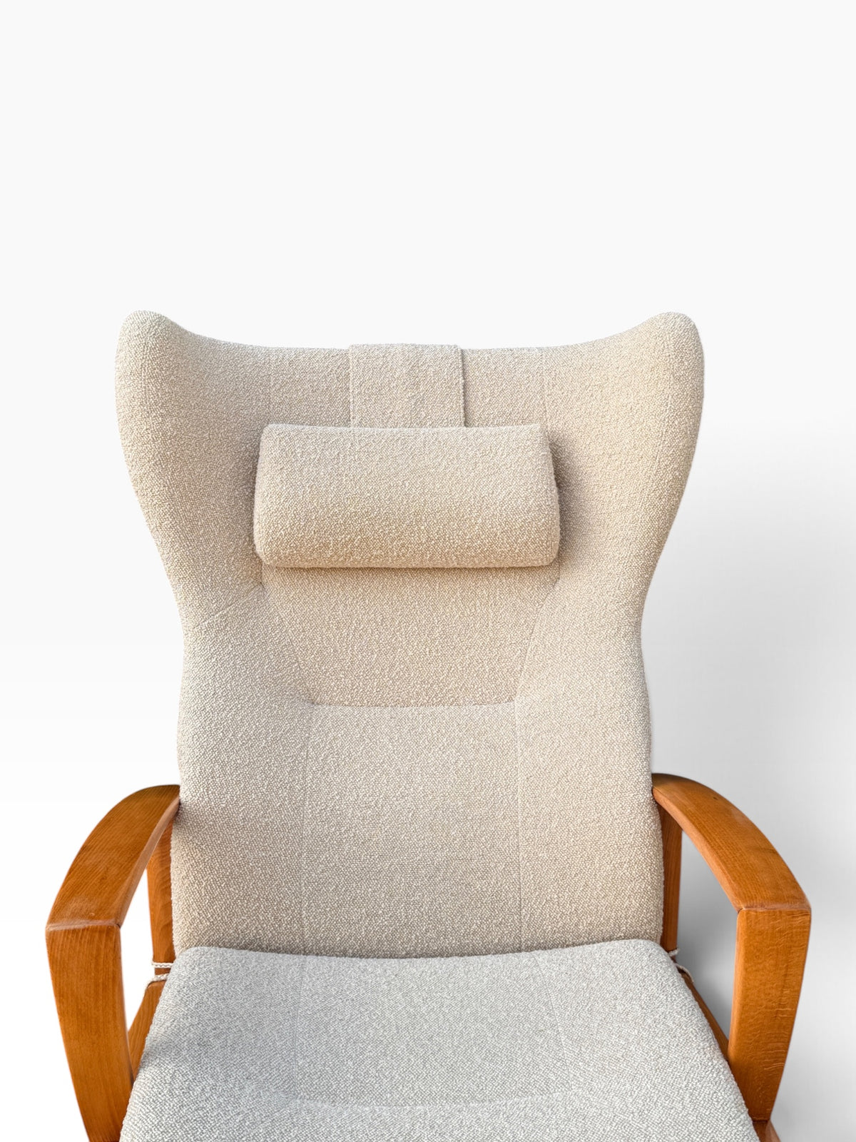 Close-up of high winged back and boucle headrest pillow