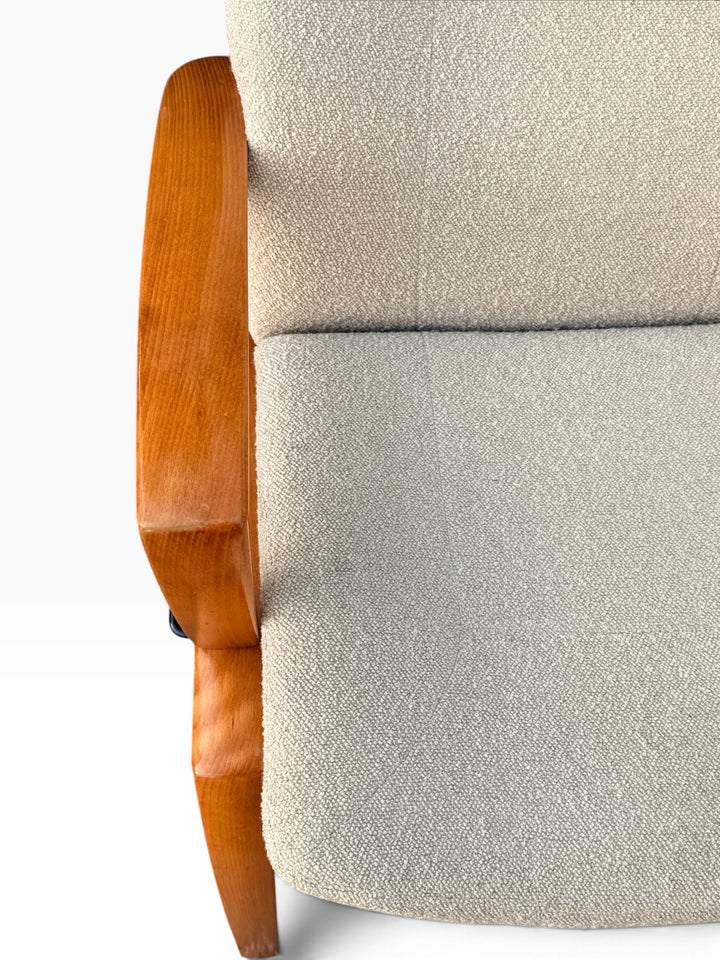 Close-up of boucle seat and wood armrest