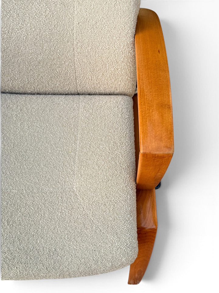 Detail of creamy boucle upholstery and armrest