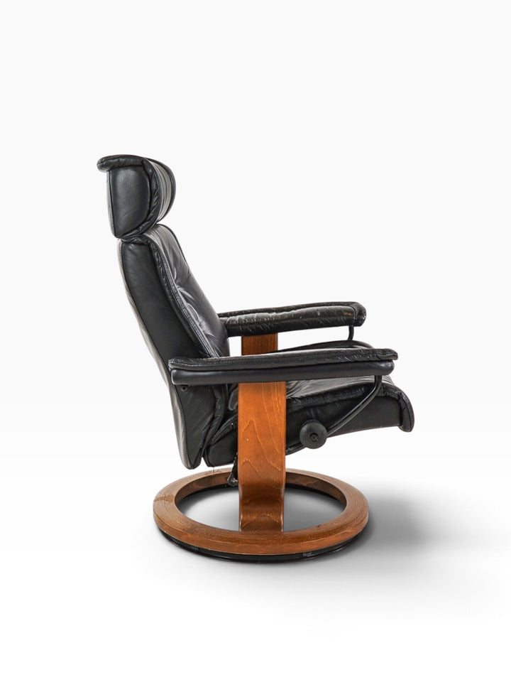 Side profile of the Ekornes Stressless recliner showing teak cantilever support and swivel base