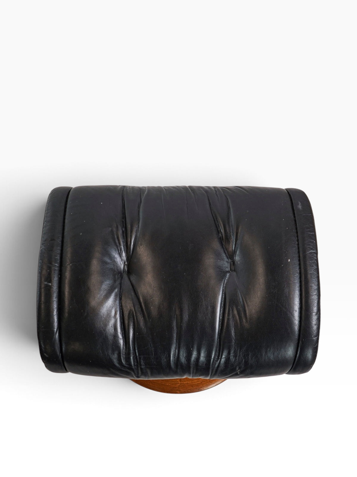 Matching black leather Stressless ottoman on teak swivel base