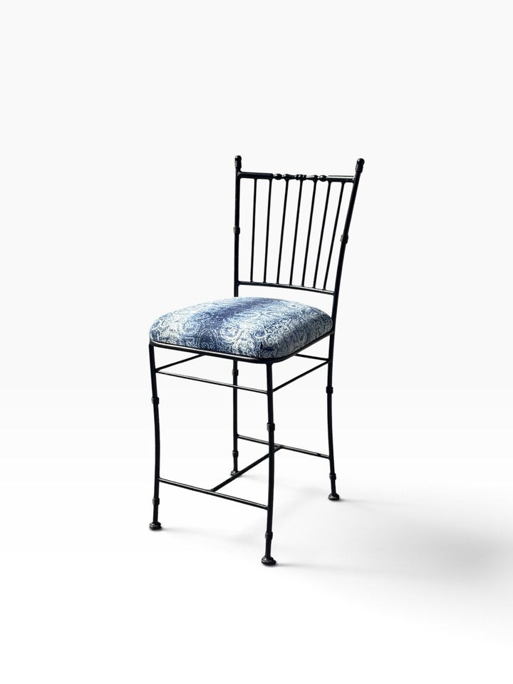 Three-quarter view of the faux bamboo counter stool showing the ringed leg accents
