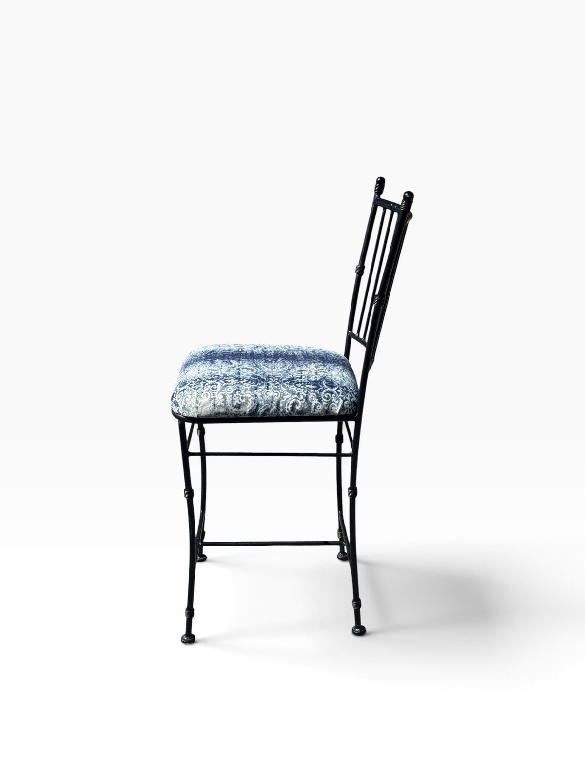 Side profile of the counter stool showing the angled back and footrest stretchers