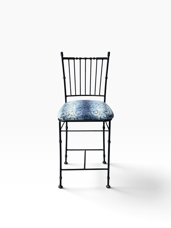 Straight-on front view of the faux bamboo wrought iron counter stool