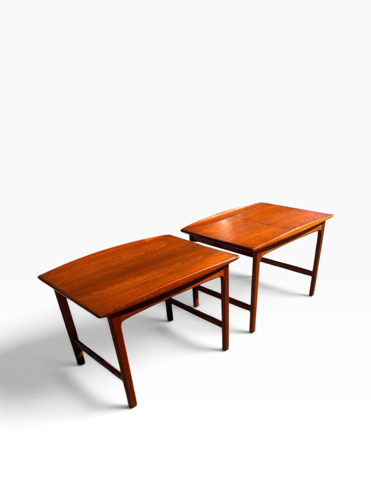 Pair of Swedish teak surfboard end tables, angled view
