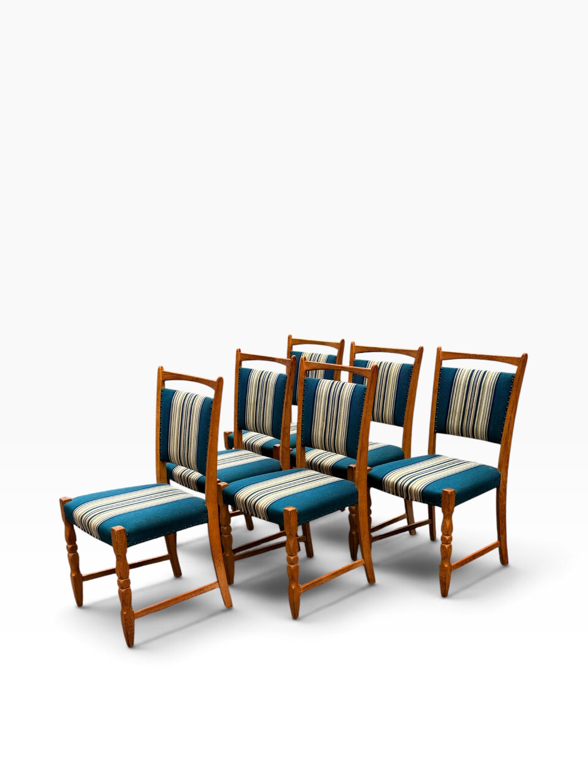 Six Kjærnulf oak dining chairs, angled group view