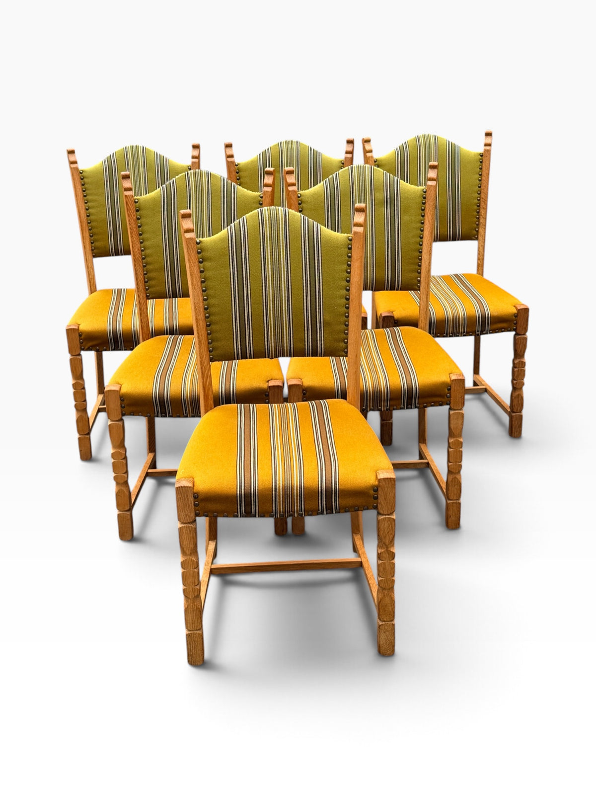 Six oak dining chairs with arched backs, grouped view