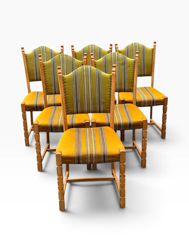 Six oak dining chairs with arched backs, grouped view