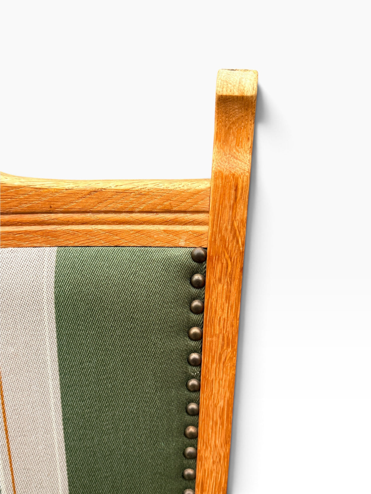 Brass nailhead trim and oak frame detail